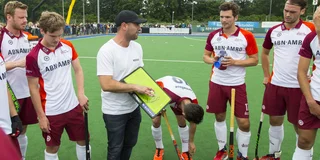 Gademan geeft met bord en magneten uitleg aan de heren van Almere tijdens de rust. 